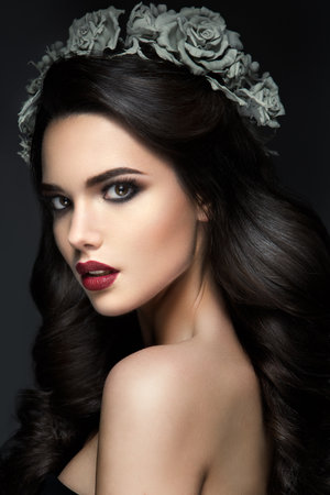 Beauty Fashion Model Girl Portrait with Grey Roses Hairstyle. Red Lips. Beautiful Luxury Makeup and Hairの写真素材