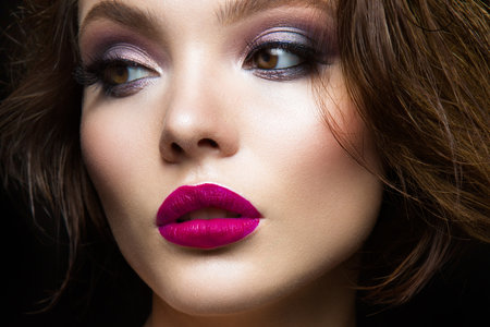 Beautiful young model with pink lips and dark makeapの写真素材