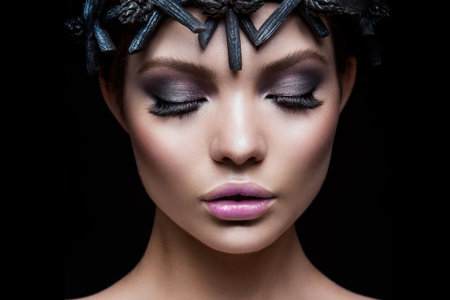 Close-up portrait of beautiful woman with bright make-up. Black accessories.の写真素材
