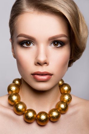 Fashion Model Portrait. Hairstyle, Professional Makeup and False Eyelashes. Gold Make-upの写真素材
