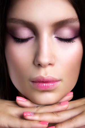 Romantic girl with beautiful makeup. Pink manicure.の写真素材