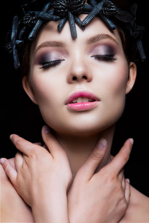 Close-up portrait of beautiful woman with bright make-up. Black accessories.の写真素材