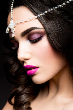 Close-up portrait of beautiful woman with bright make-up and pink lipsの写真素材