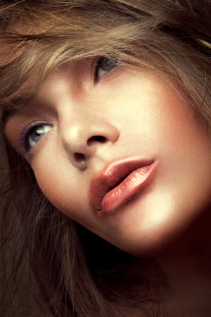 Close-up portrait of beautiful woman with bright make-up and gloss lipsの写真素材