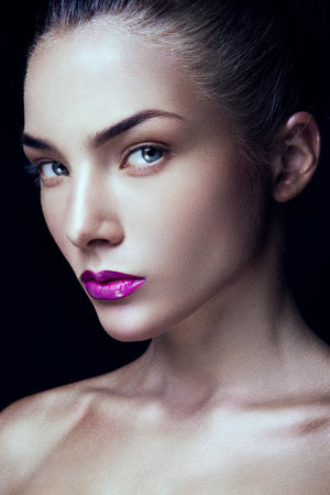 Close-up portrait of beautiful woman with bright make-up and pink lipsの写真素材
