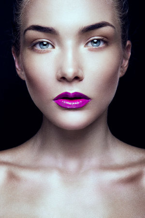 Close-up portrait of beautiful woman with bright make-up and pink lipsの写真素材