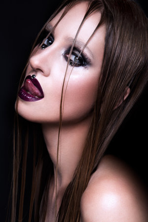 Portrait of gothic girl with blue eyes in dark clothes. Dark Lips.の写真素材