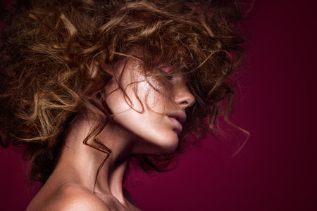 Close-up portrait of beautiful woman with bright make-up and hairstyle.