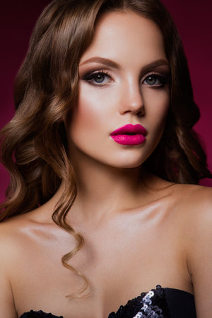 Close-up portrait of beautiful woman with bright make-up and hairstyle.の写真素材