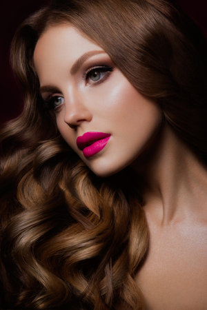 Close-up portrait of beautiful woman with bright make-up and hairstyle.の写真素材