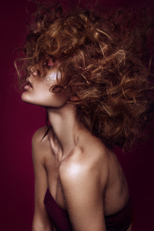 Close-up portrait of beautiful woman with bright make-up and hairstyle.の写真素材