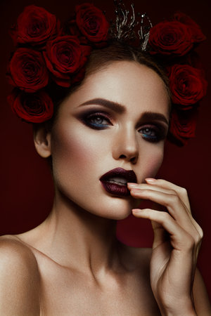 Close-up portrait of beautiful woman with dark make-up and hairstyle.の写真素材