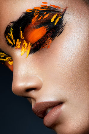 Beauty fashion model girl with dark bright orange make-up. Close up portret.の写真素材