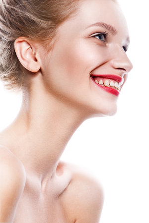 Beautiful woman face. Perfect toothy smile. Caucasian young girl close up portrait. red lips, skin, teeth. Isolated on white background. Studio shot . happy positive girl.の写真素材