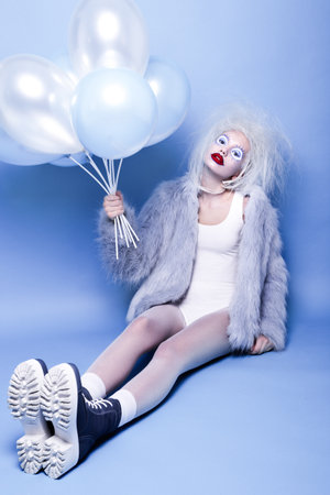 Portrait of young sensual woman with curly hair and fashion clown make-up. Fashin Clown.の写真素材