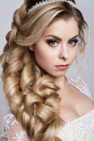 Close-up portrait of beautiful woman with bright make-up and hairstyle.の写真素材