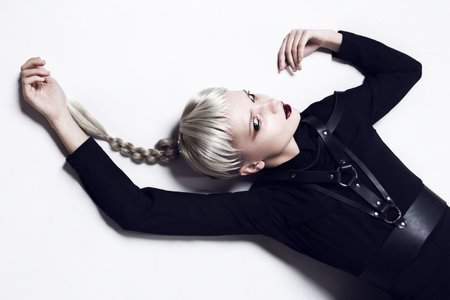 Beautiful girl lying upside down. Fashion lady.