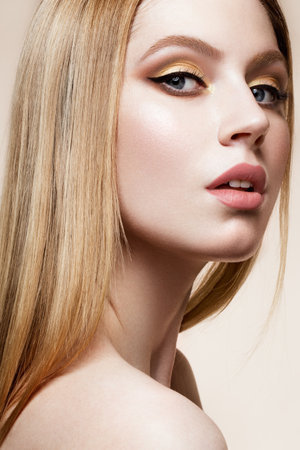 Close-up portrait of beautiful woman with bright make-up and hairstyle.の写真素材