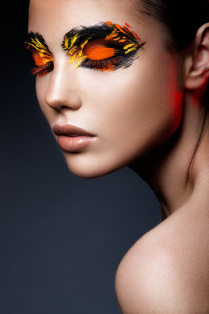 Beauty fashion model girl with dark bright orange make-up. Close up portret.の写真素材