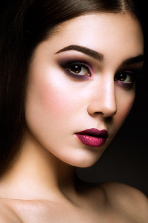 Close-up portrait of beautiful woman with bright make-up and hairstyle.の写真素材