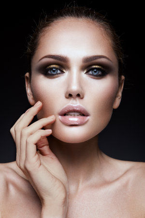 Close-up portrait of beautiful woman with bright make-up and hairstyle.の写真素材