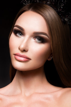 Close-up portrait of beautiful woman with bright make-up and hairstyle.の写真素材