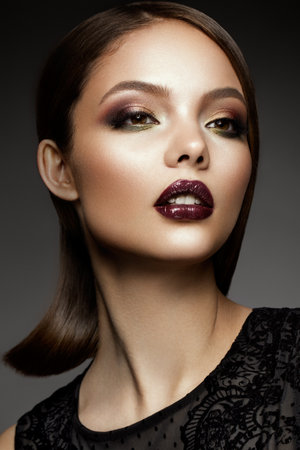 Beautyful girl with bright make up and beautiful hairstyleの写真素材