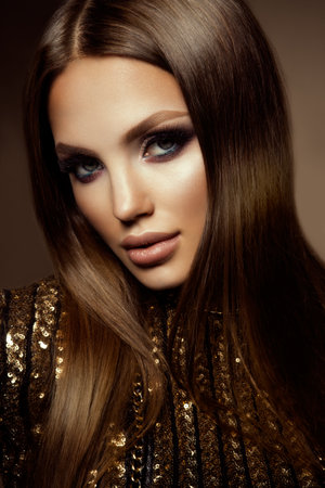Make up. Glamour portrait of beautiful woman model with fresh makeup and romantic hairstyle.の写真素材