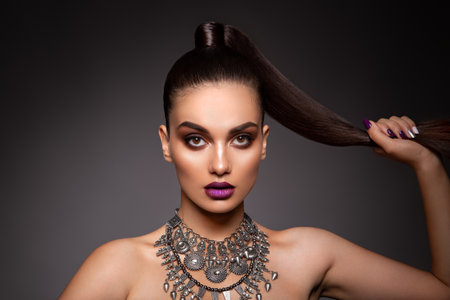 Beauty Brunette Woman with Perfect Makeup. Beautiful Professional Holiday Make-up.の写真素材