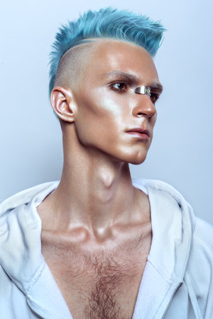 Profile of a handsome man with blue hairの写真素材