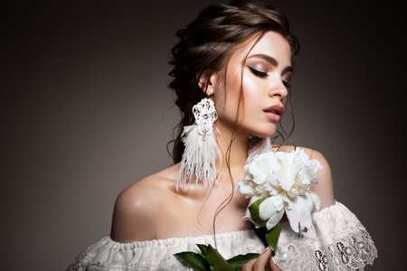 Glamour portrait of beautiful woman model with fresh daily makeup and romantic wavy hairstyle.の写真素材