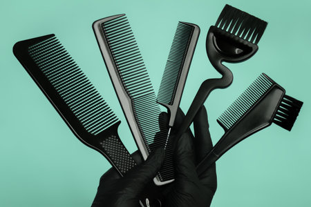 Composition with scissors and other hairdresser's accessories on green background, top viewの写真素材