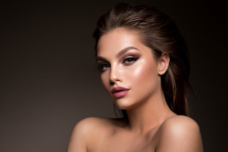 Glamour portrait of beautiful woman model with fresh daily makeup and romantic hairstyle.の写真素材