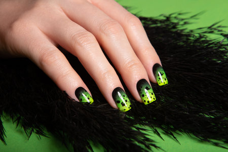 Female neat hand with short natural nails painted with green nail polish. Natural, cozy, elegant, modern look.の写真素材
