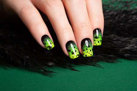 Female neat hand with short natural nails painted with green nail polish. Natural, cozy, elegant, modern look.の写真素材