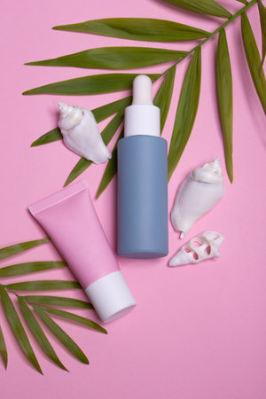Beauty background with facial cosmetic products with empty copy space. Makeup, skin care concept with pastel colored background.の写真素材