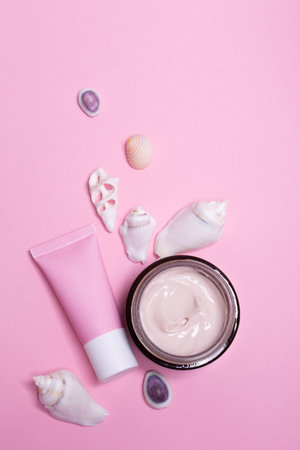 Beauty background with facial cosmetic products with empty copy space. Makeup, skin care concept with pastel colored background.の写真素材