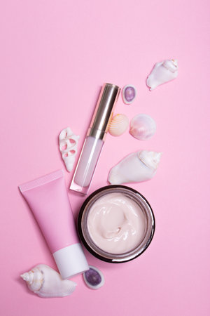 Beauty background with facial cosmetic products with empty copy space. Makeup, skin care concept with pastel colored background.の写真素材