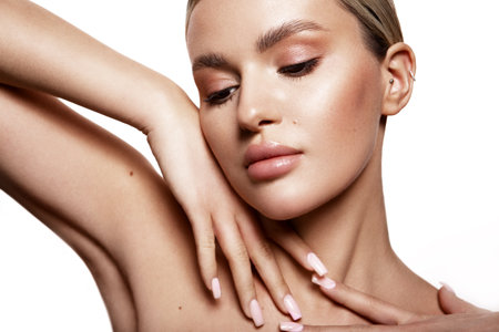 Beauty portrait of model with natural make-up. Fashion shiny highlighter on skin, sexy gloss lips make-upの写真素材
