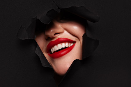 Beautiful woman with perfect skin on black background. Beauty and skin care concept.の写真素材