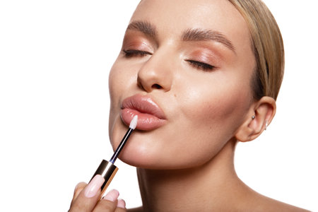 Beauty portrait of model with natural make-up. Fashion shiny highlighter on skin, sexy gloss lips make-upの写真素材