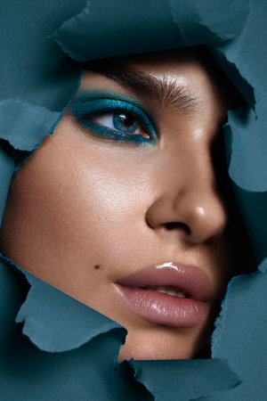 Beautiful woman with perfect skin on blue background. Beauty and skin care concept.の写真素材