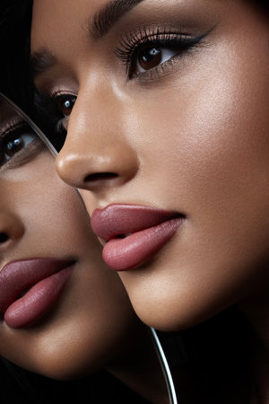 A stunning beauty shot featuring glittery makeup paired with an elegant and graceful poseの写真素材