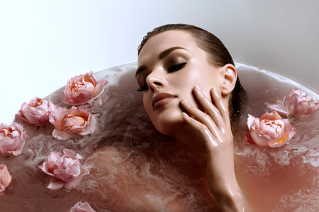 An Ethereal Woman Relaxing in a Beautiful Floral Bathtub Surrounded by Natures Beautyの写真素材