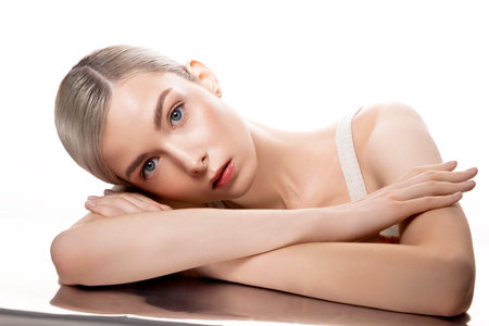 A woman is lying on a table with her armの写真素材