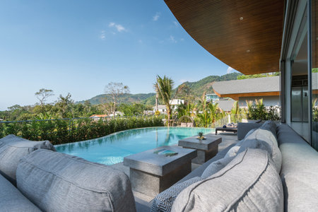 Interior and exterior design of pool villa, house, and home feature sun bed and infinity swimming...
