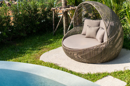 Exterior design of villa, house and home feature round shape sun bed and cushion by swimming pool