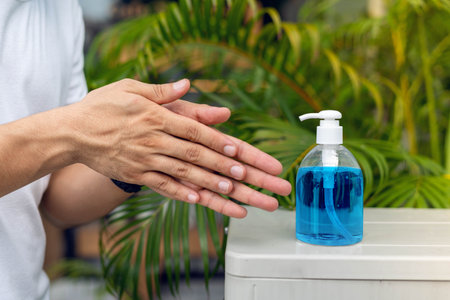 Washing hands with alcohol gel to protect from coronavirus or covid-19の写真素材