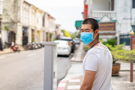 Asian man is wearing surgical mask during covid19 or corona virus spreadの写真素材