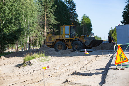 Repair of the road in the center of the city of Noyabrsk on Yamal in summer